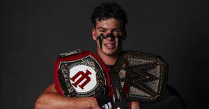 Declan McMahon poses with the IU Takeaway Belt and the WWE Universal Championship. (Photo Credit: Declan McMahon)