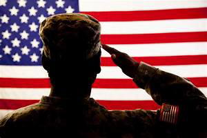 An American soldier salutes the American flag.