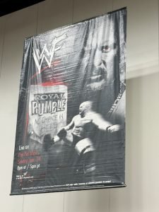 The poster for "WWF Royal Rumble 1999" hung above the superstore.